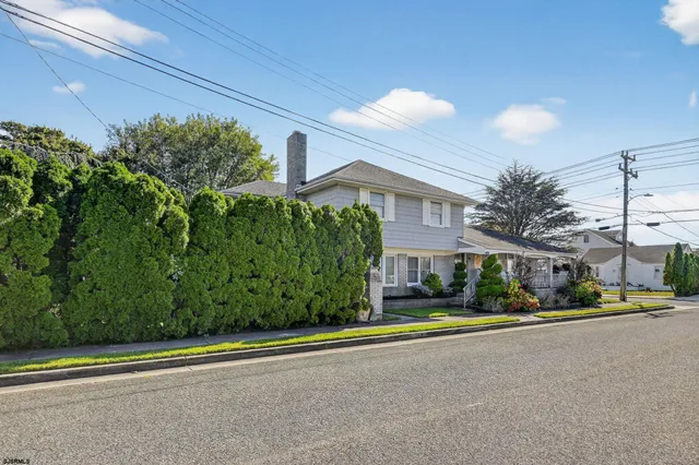 a living room with furniture a flat screen tv and a floor to ceiling window