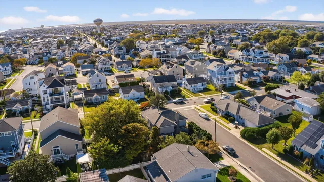 a view of a dining room with furniture a chandelier and wooden floor
