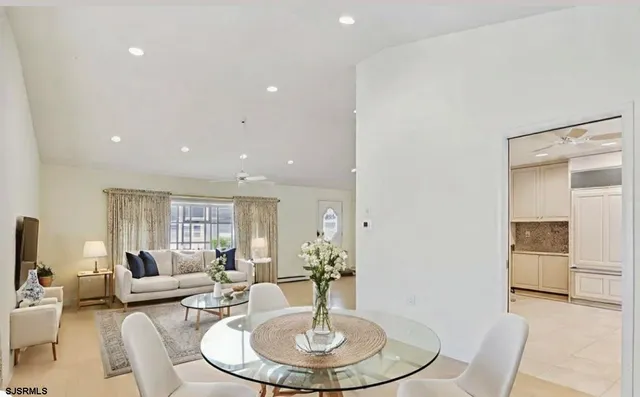 a living room with furniture a window and a flat screen tv