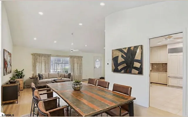 a living room with furniture a flat screen tv and a window