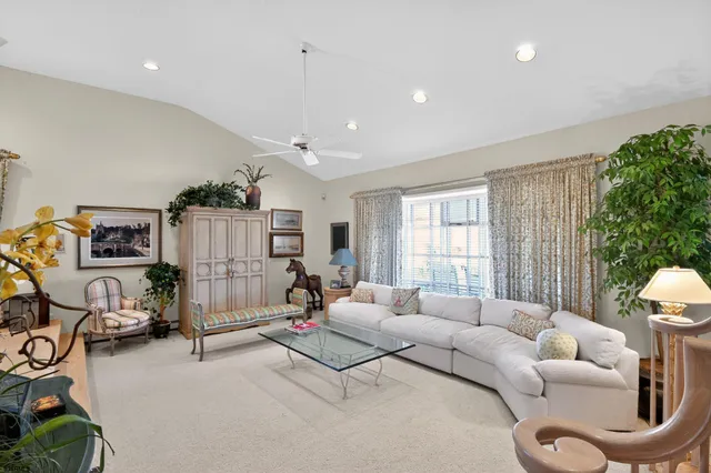 a view of a dining room with furniture and a chandelier