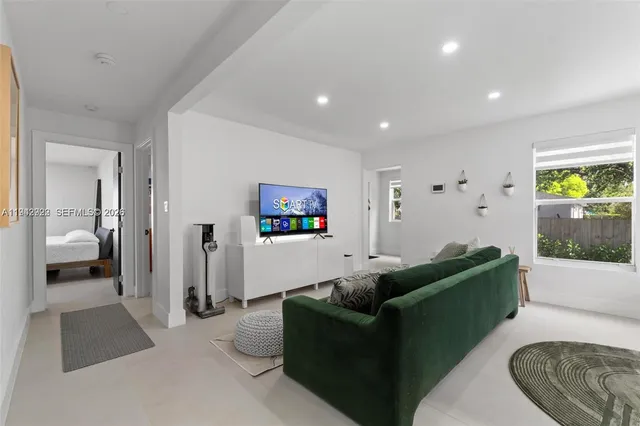 a living room with furniture and a walk in closet