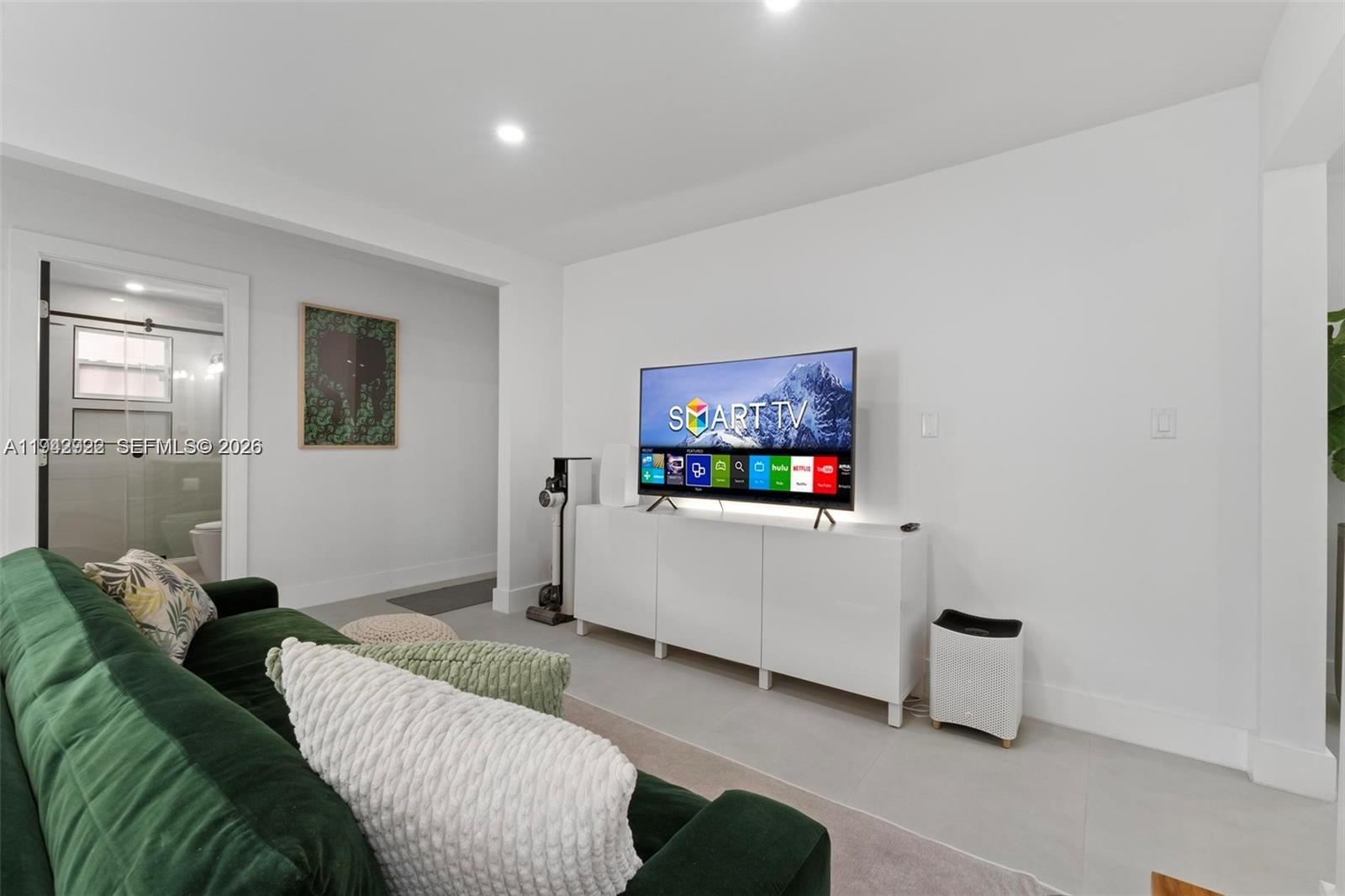 4430 Northwest 1st Avenue Miami, FL 33127 - Photo 15 of 31 a living room with furniture and a flat screen tv