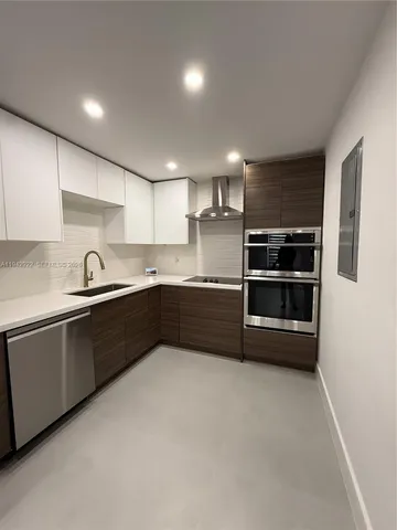 a kitchen with stainless steel appliances a sink and cabinets
