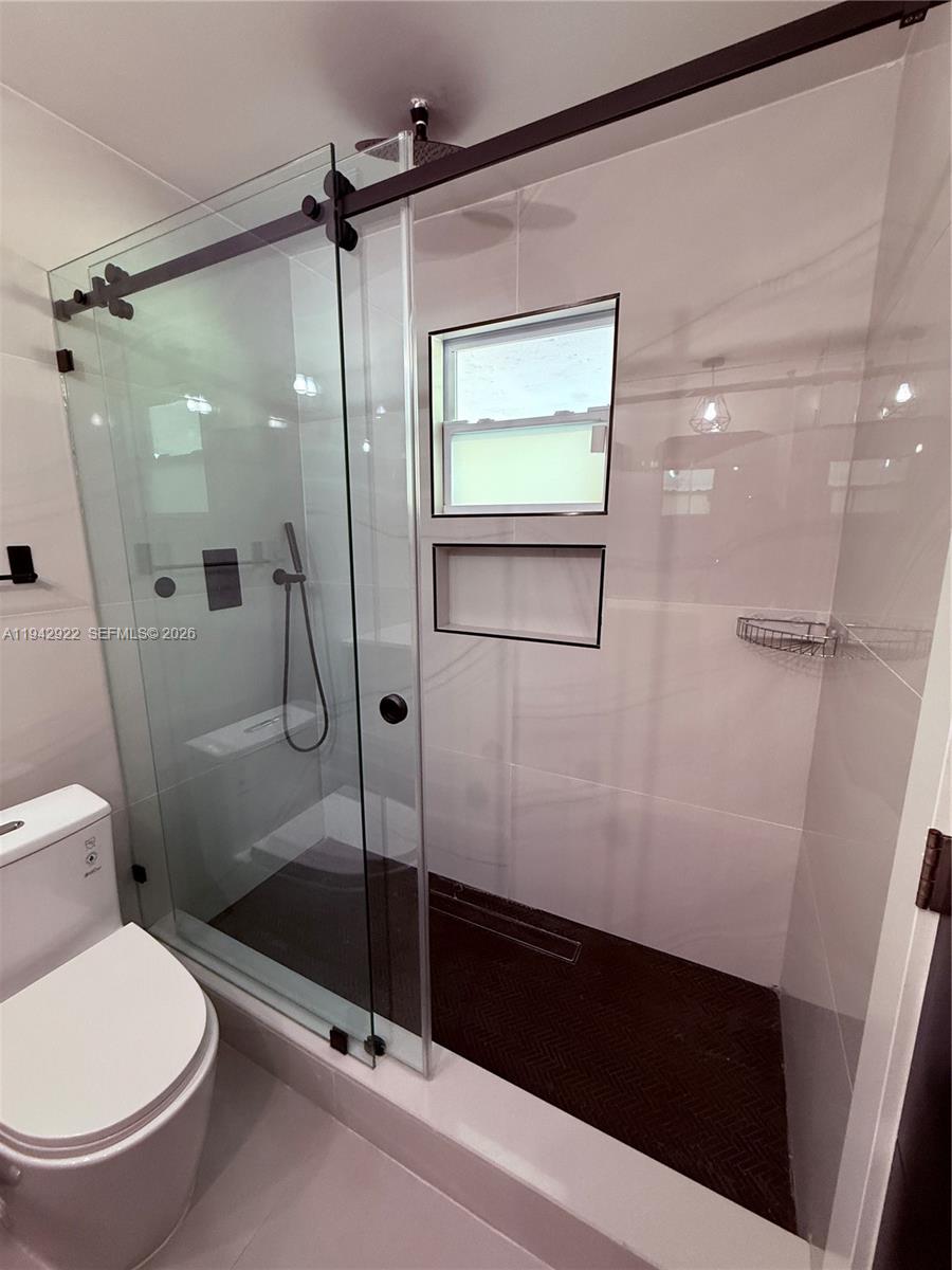 4430 Northwest 1st Avenue Miami, FL 33127 - Photo 27 of 31 a bathroom with a shower and a toilet