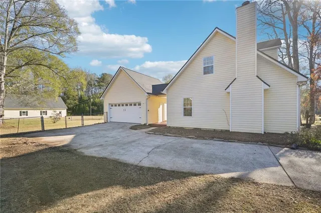 a view of a house with a yard and garage