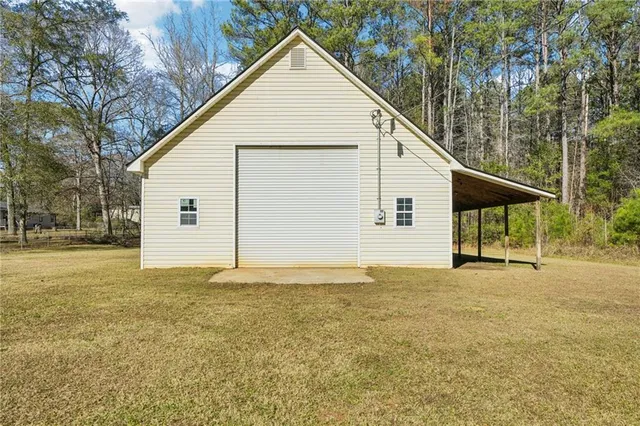 a view of a house with a yard and garage