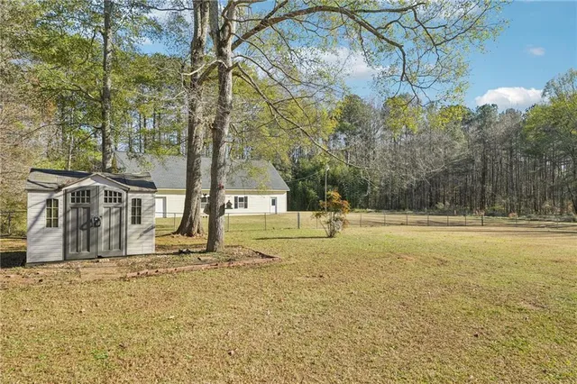 a view of yard with swimming pool and trees