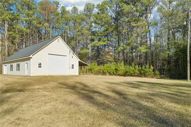 a view of a large house with a yard and large trees