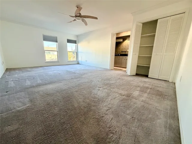 a view of empty room with a fireplace and cabinet