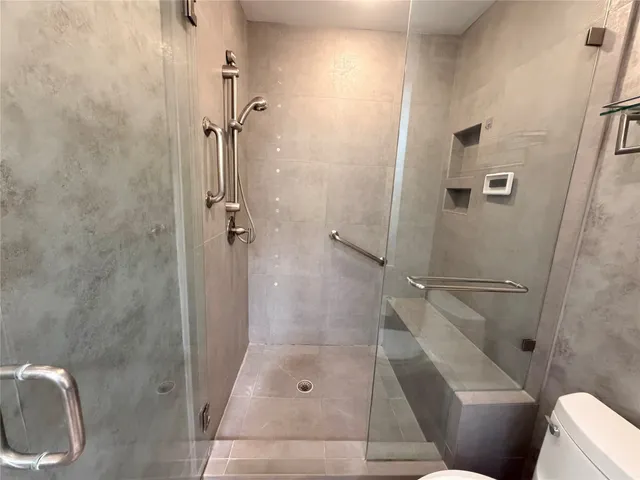 a bathroom with a shower and toilet