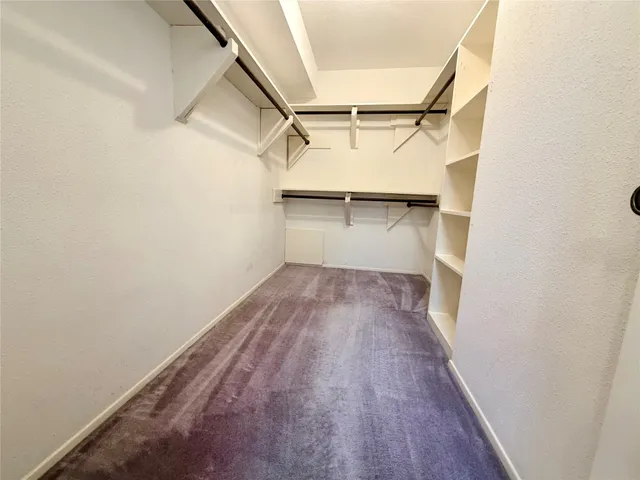 a view of a room with wooden floor and window