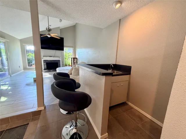 a kitchen with a refrigerator and a wooden floor