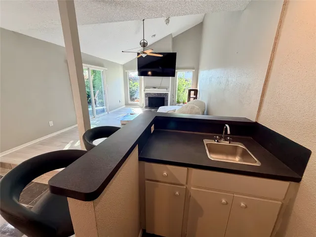 a kitchen with a sink cabinets and wooden floor