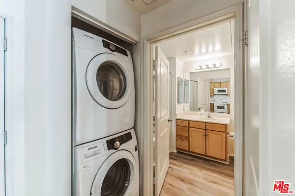 a utility room with sink dryer and washer