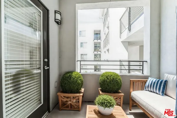 a view of a balcony filled with furniture