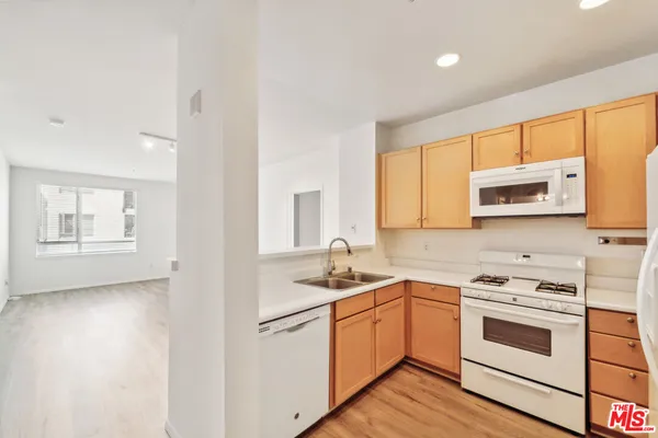 a kitchen with a stove a sink and a microwave