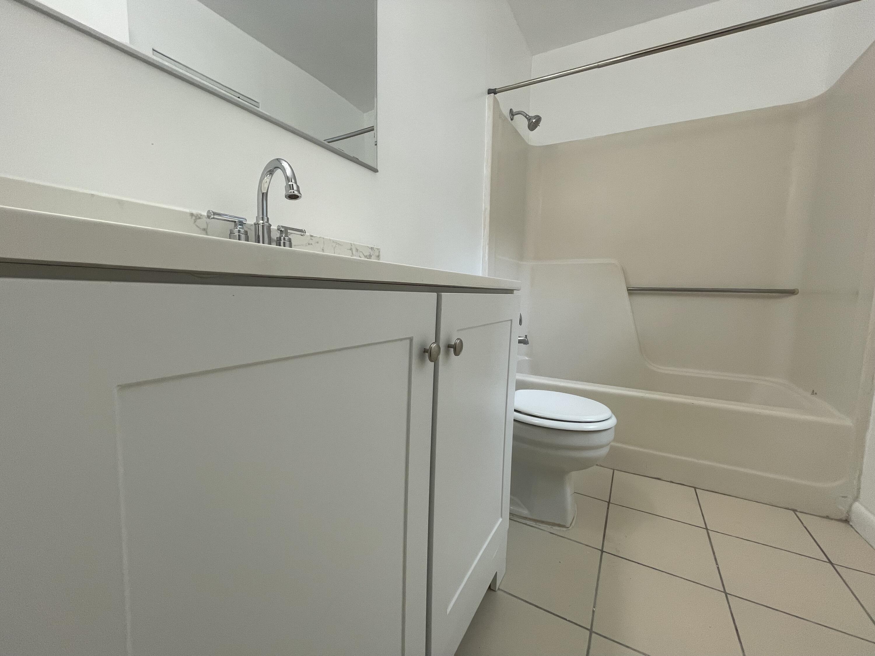 28 Crossings Circle, Unit B Boynton Beach, FL 33435 - Photo 11 of 19 a bathroom with a granite countertop sink toilet and shower