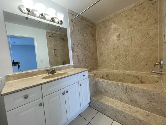 a view of a kitchen with a sink and cabinets