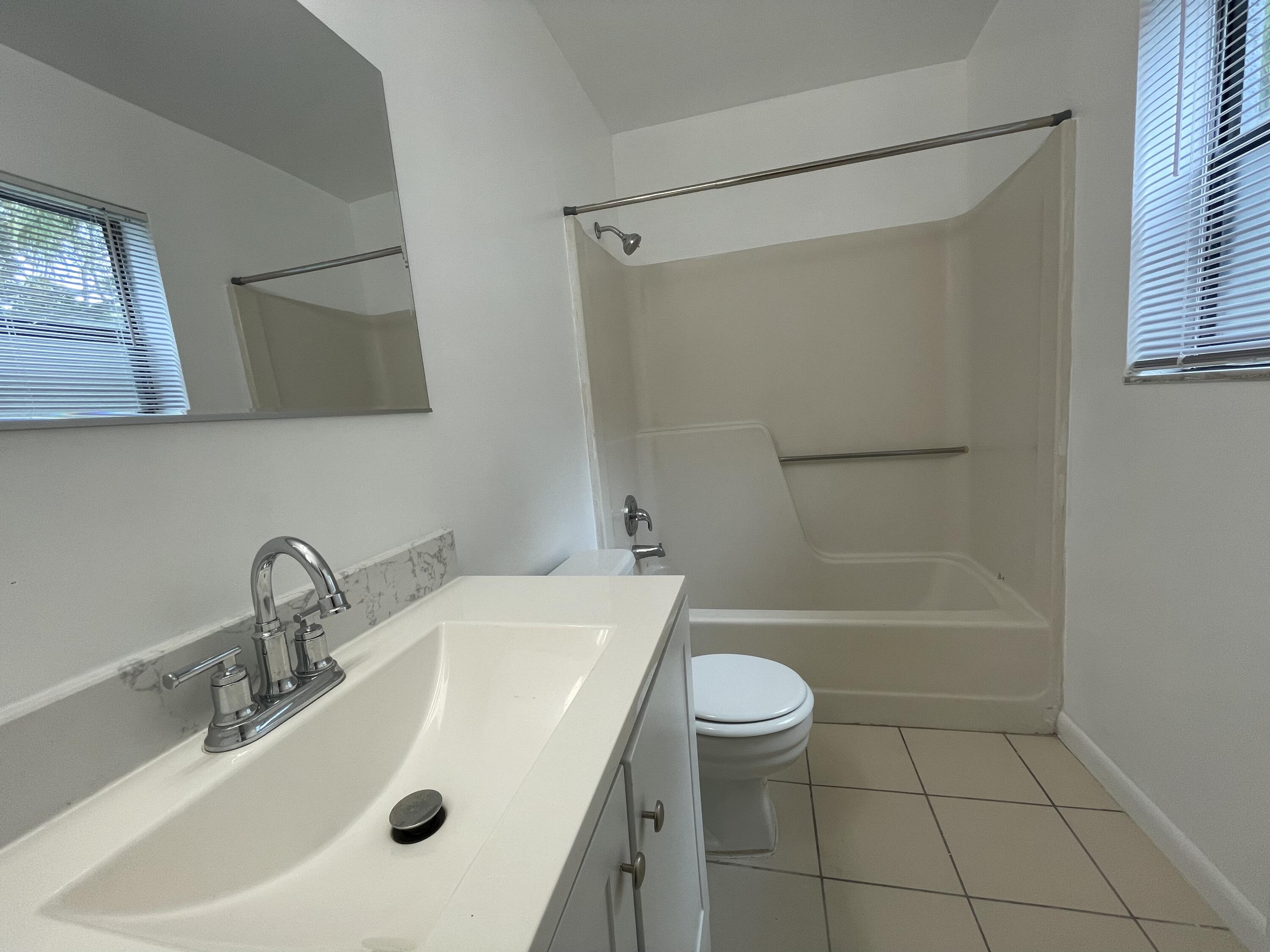 28 Crossings Circle, Unit B Boynton Beach, FL 33435 - Photo 10 of 19 a bathroom with a sink a toilet and shower