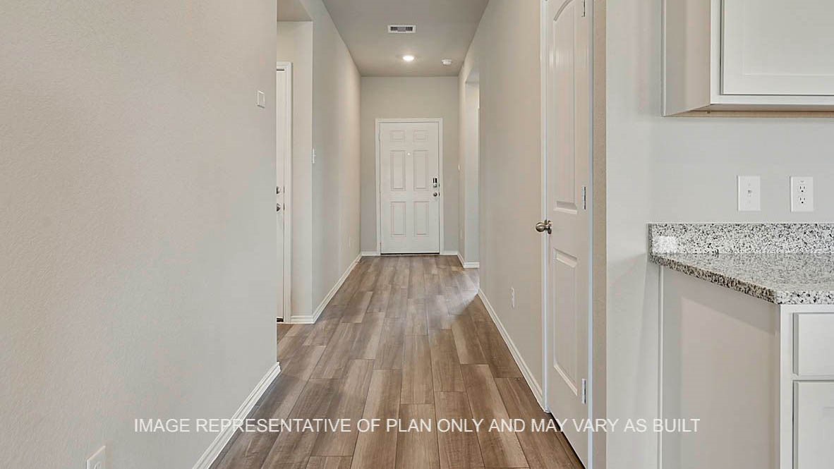 1026 Legrand Street Brenham, TX 77833 - Photo 12 of 16 a view of a hallway with wooden floor
