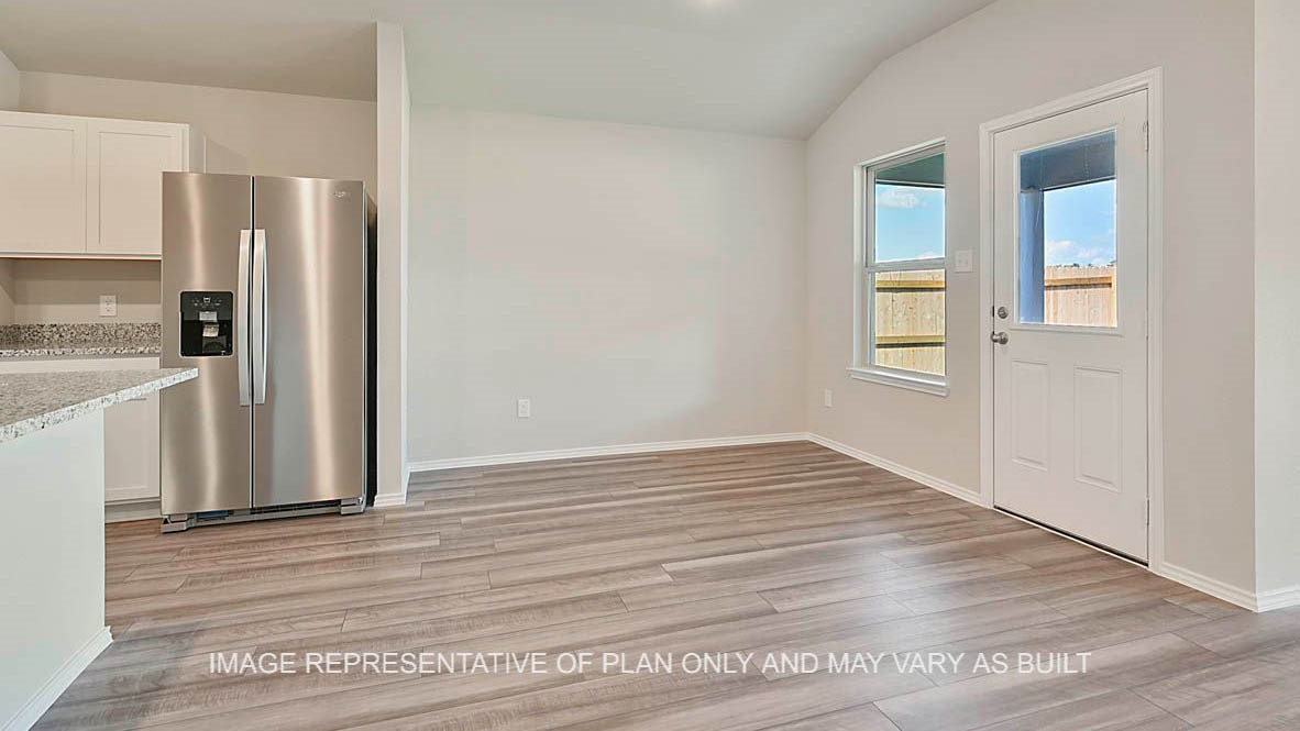 1026 Legrand Street Brenham, TX 77833 - Photo 14 of 16 a view of a kitchen with wooden floor and a refrigerator