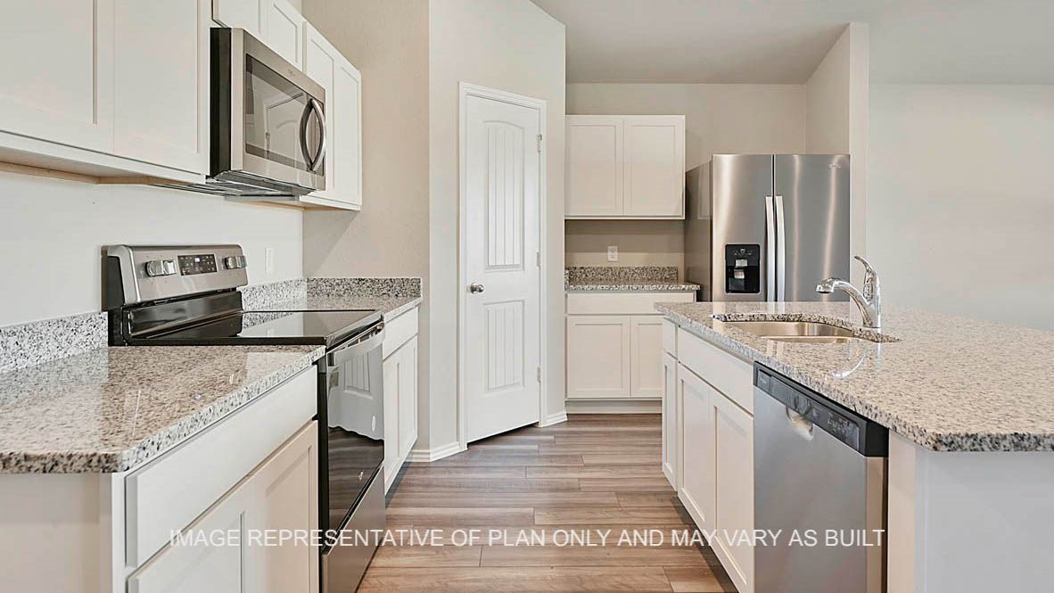 1026 Legrand Street Brenham, TX 77833 - Photo 15 of 16 a kitchen with stainless steel appliances granite countertop a sink stove and refrigerator