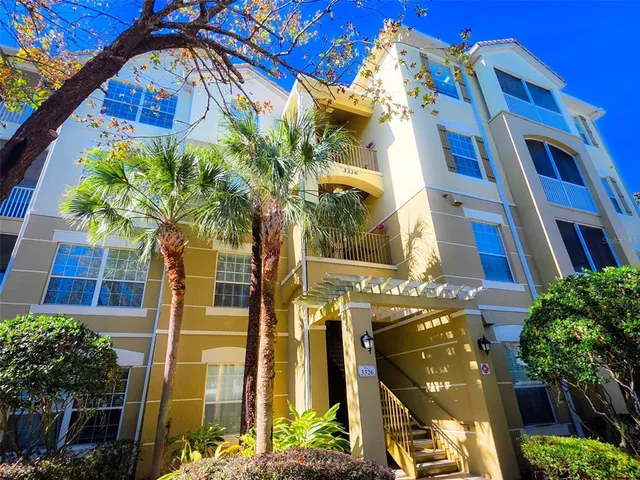 a front view of a multi story residential apartment building with a yard