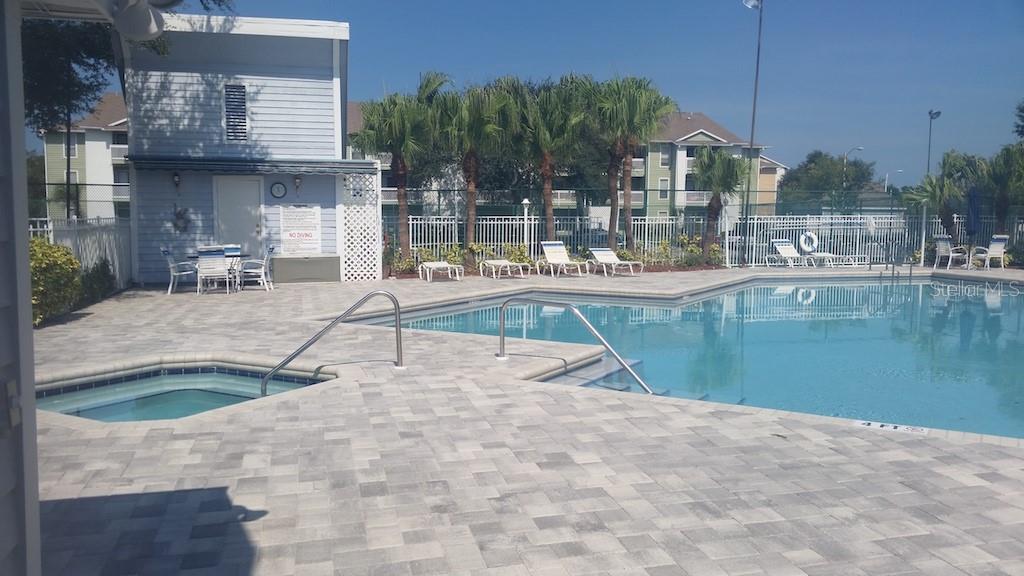 455 Alt 19, Unit 65 Palm Harbor, FL 34683 - Photo 11 of 11 a swimming pool with outdoor seating and yard