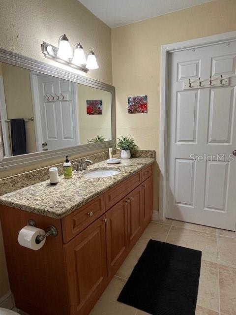 455 Alt 19, Unit 65 Palm Harbor, FL 34683 - Photo 9 of 11 a bathroom with a granite countertop sink and a mirror