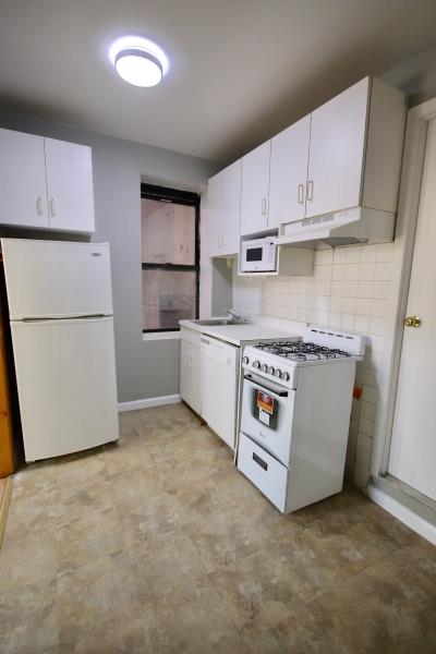 a utility room with stainless steel appliances granite countertop a washer and dryer