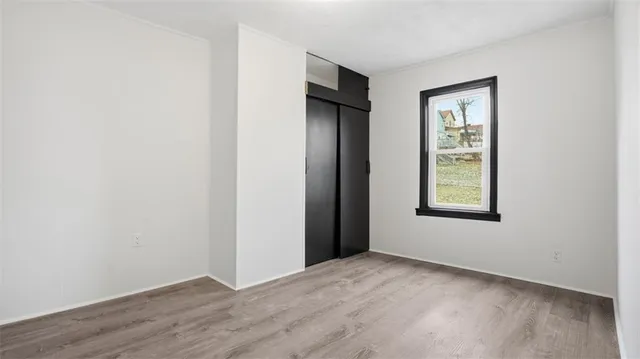 an empty room with windows and closet