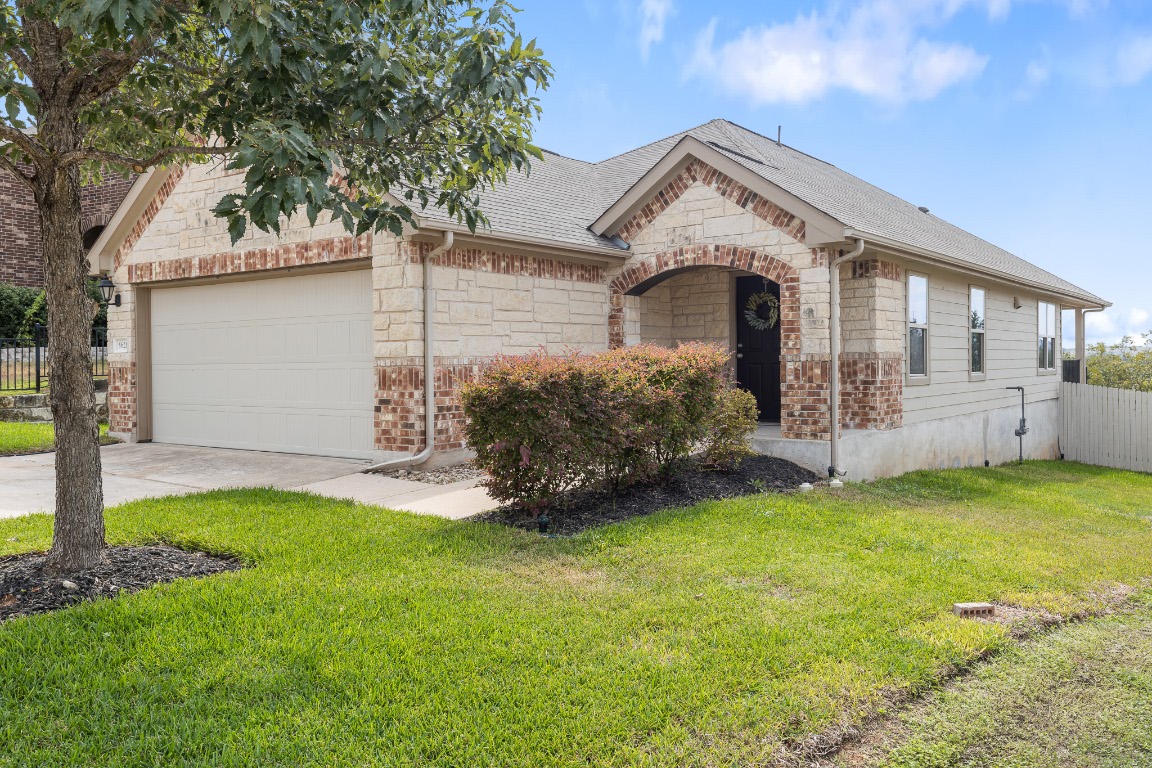 5621 Little Theater Bend Austin, TX 78747 - Photo 2 of 38 a front view of a house with a garden and yard