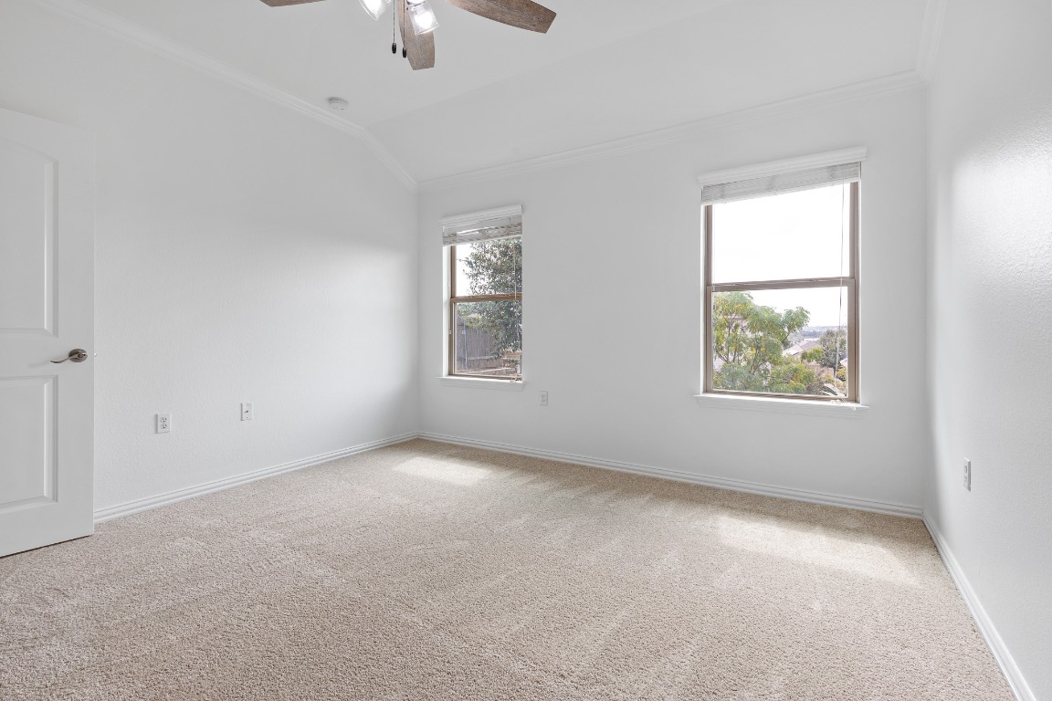 5621 Little Theater Bend Austin, TX 78747 - Photo 24 of 38 an empty room with windows and chandelier fan