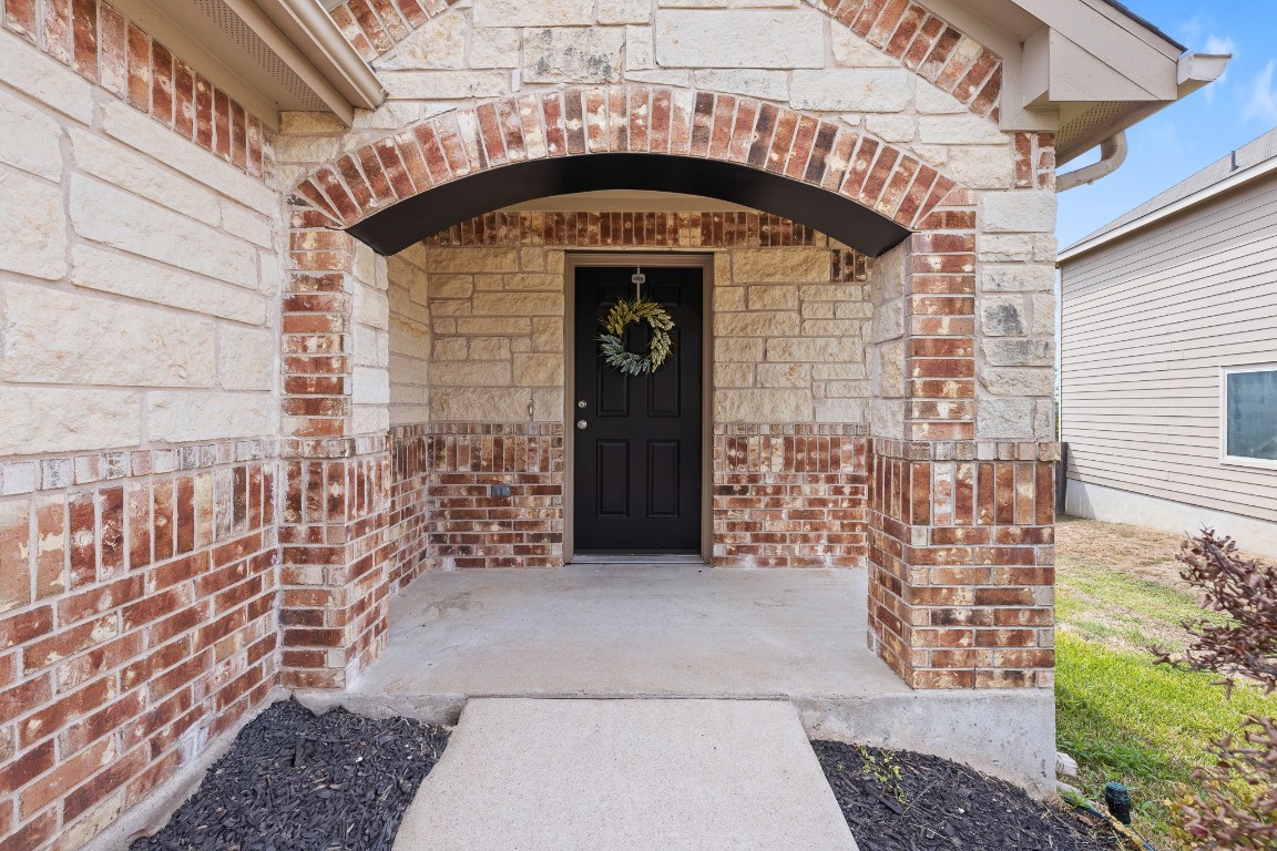 5621 Little Theater Bend Austin, TX 78747 - Photo 3 of 38 a front view of a building with a door
