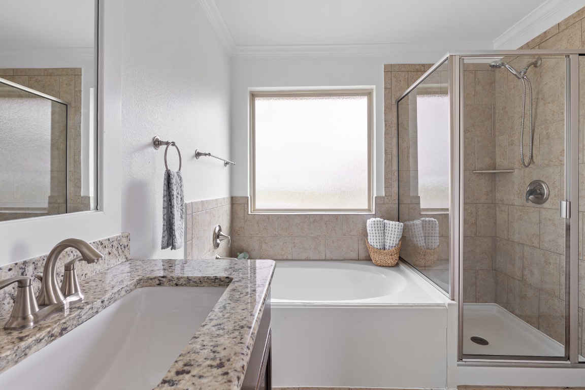 5621 Little Theater Bend Austin, TX 78747 - Photo 31 of 38 a bathroom with a tub sink and mirror
