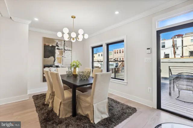 a view of a dining room with furniture and chandelier