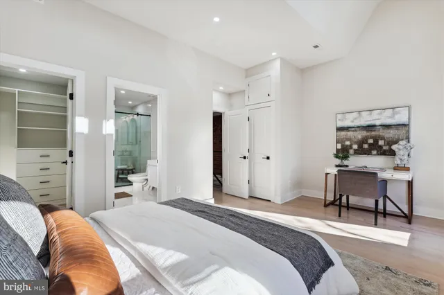 a spacious bedroom with a bed and a table in it