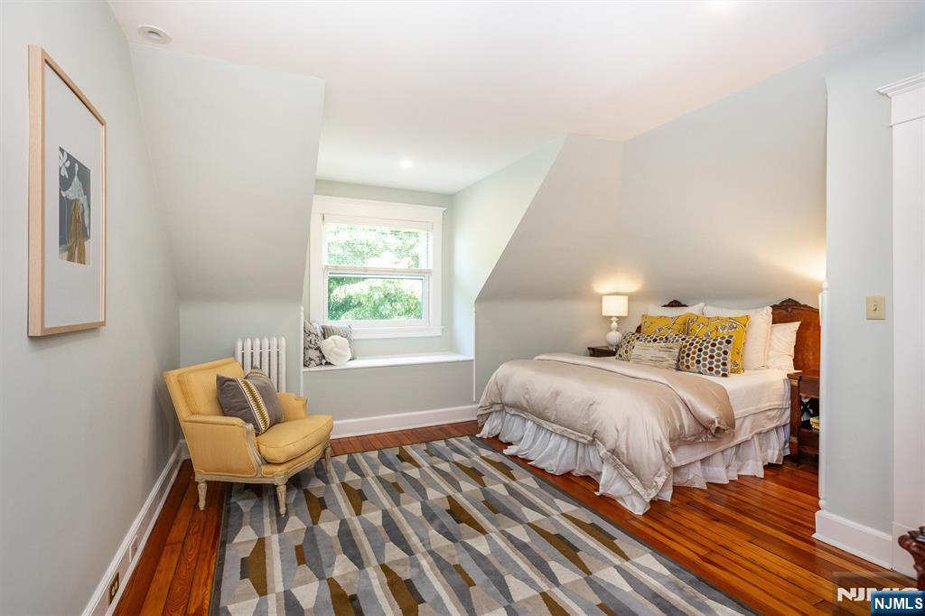 380 Ridgewood Avenue Glen Ridge, NJ 07028 - Photo 39 of 50 a spacious bedroom with a bed and a chair