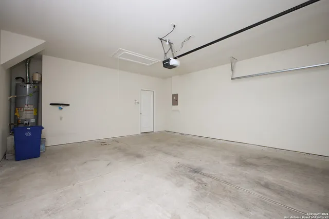a view of a room with a ceiling fan and window