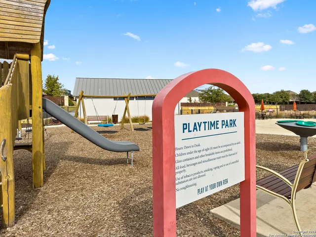 a view of a swimming pool with a bench and floor to ceiling window