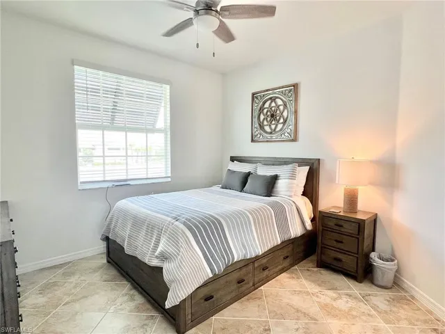 a bathroom with a granite countertop sink a large mirror and a toilet