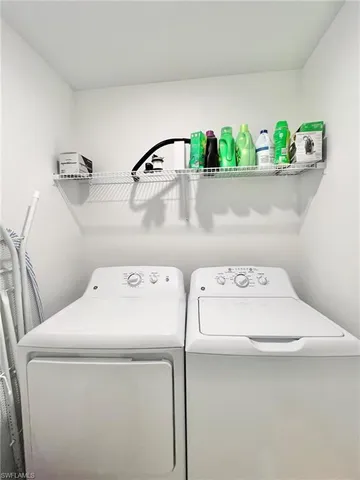 a front view of multi story residential apartment building with yard and retail shops