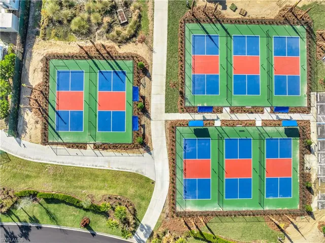 a view of swimming pool with a table and chairs in front of it