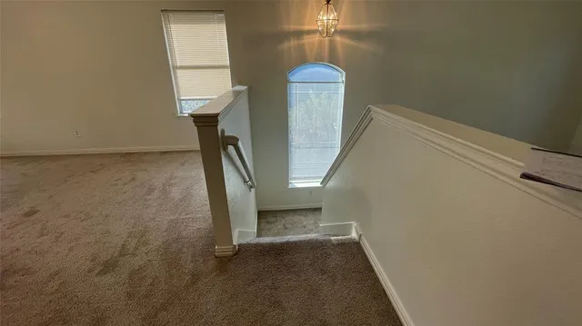 an empty room with a empty space and windows