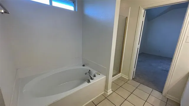 an empty room with chandelier fan