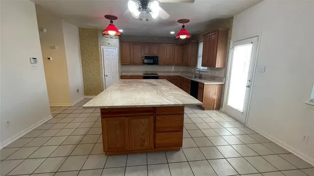 a view of a kitchen with granite countertop cabinets