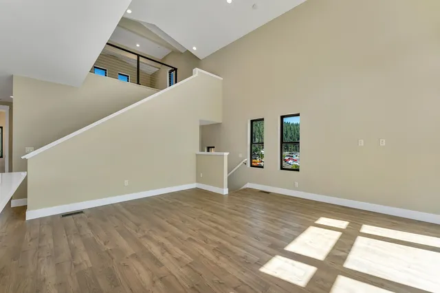 a view of an entryway with wooden floor and stair