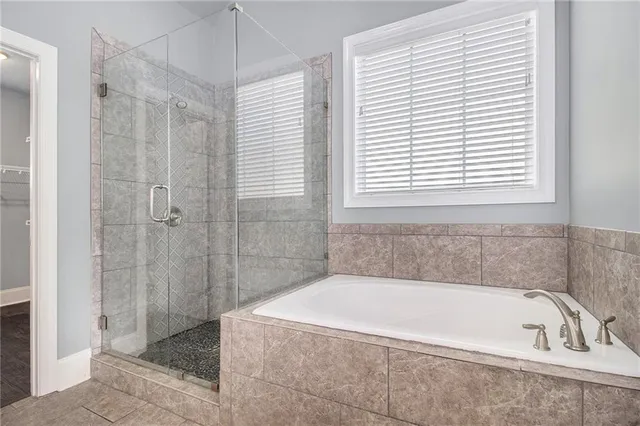 a bathroom with a bathtub and shower