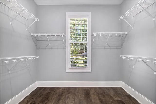 a view of a room with racks on the wall and a window